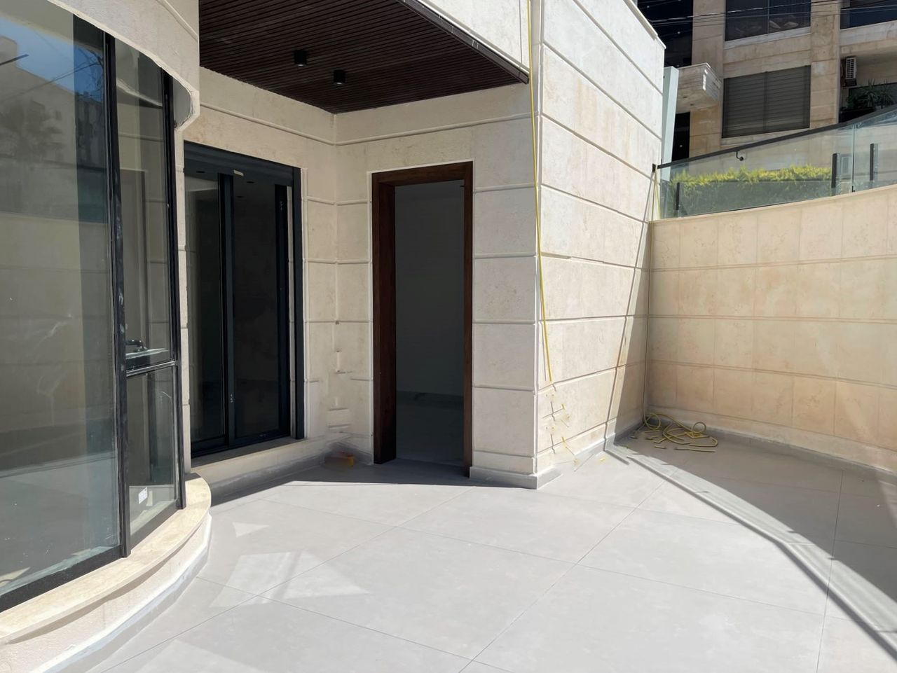 A private terrace outside the sliding doors, walled and paved.